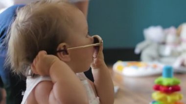 Güneş gözlüklü mutlu küçük bir kızın yakın plan portresi.