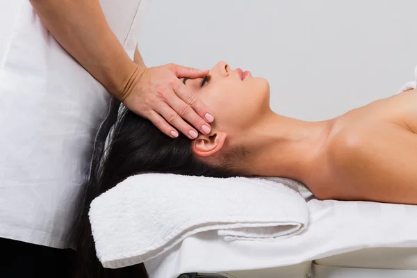 Woman massagist make face lifting massage in spa wellness center — Stock Photo, Image
