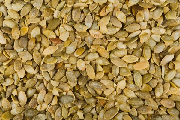 Kupie nasiona dyni zbliżenie jako żywność streszczenie tło — Zdjęcie stockowe