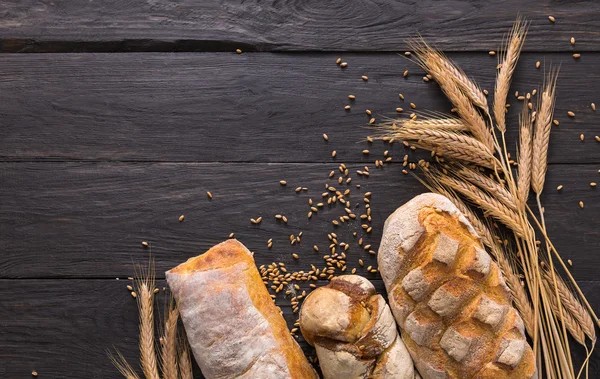 Bread bakery background. Brown and white wheat grain loaves composition