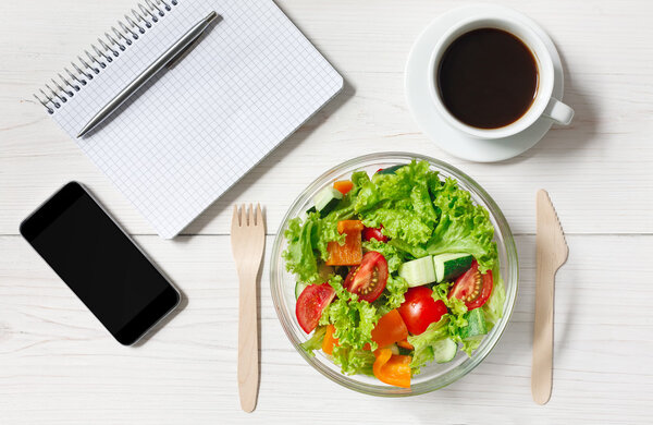 Healthy business lunch snack in office, vegetable salad top view