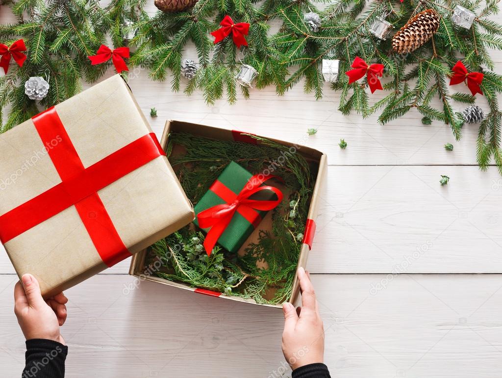 Wrapping christmas present gift on white wood background