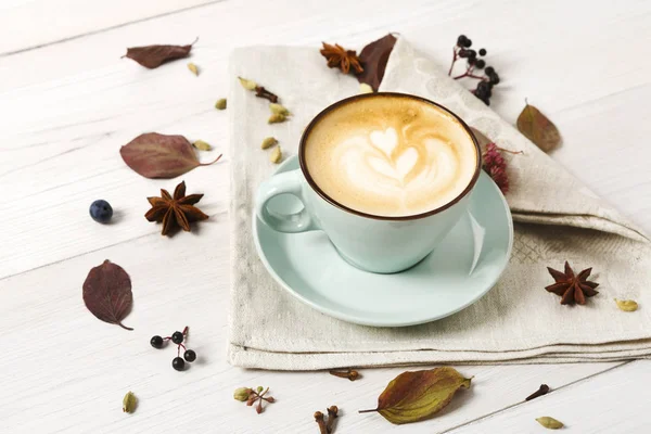 Autumn cappuccino coffee cup on white wood background — Stock Photo, Image