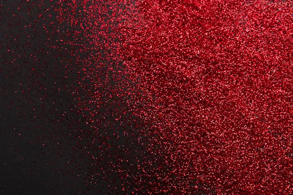 Rosso glitter sabbia texture su sfondo nero, astratto . — Foto Stock