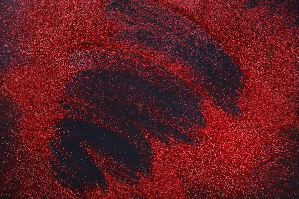 Rode glitter zand textuur op zwart, abstracte achtergrond. — Stockfoto