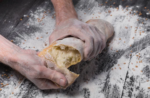 Концепция булочной. Руки ломают хлеб. — стоковое фото