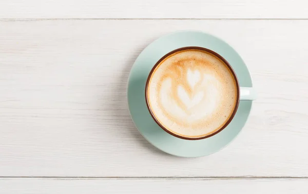Cappuccino-Schaum, Kaffeetasse von oben auf weißem Holzhintergrund — Stockfoto