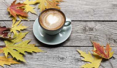 Sonbahar cappuccino kahve Kupası rustik ahşap arka plan üzerinde