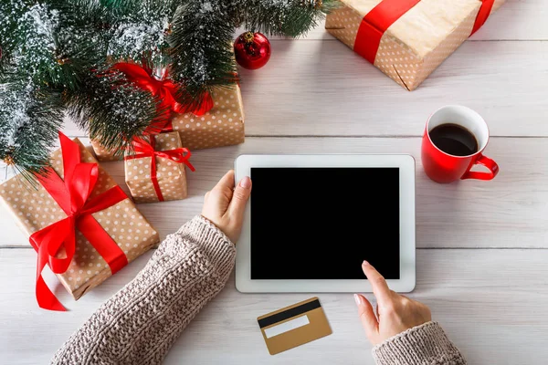 Woman shristmas shopping online with a credit card