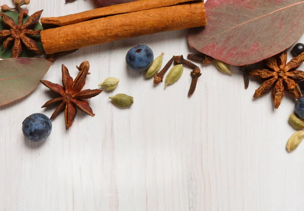 Autumn spices background on white wood, Top view. — Stock Photo, Image