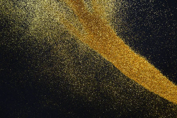 Goldene Glitzersandtextur auf schwarzem, abstraktem Hintergrund. — Stockfoto