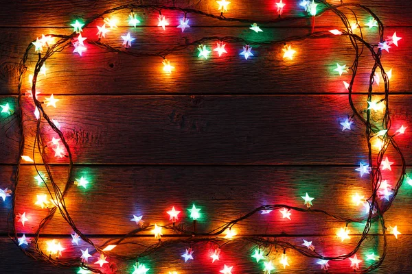 Luces de Navidad borde sobre fondo de madera —  Fotos de Stock