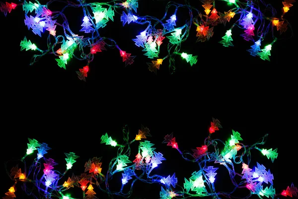 Vánoční světla hranice na černém pozadí — Stock fotografie
