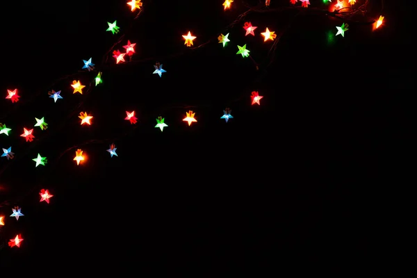 Christmas lights border on black background — Stock Photo, Image