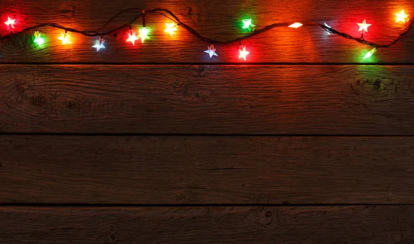 Noël lumières bordure sur fond bois — Photo