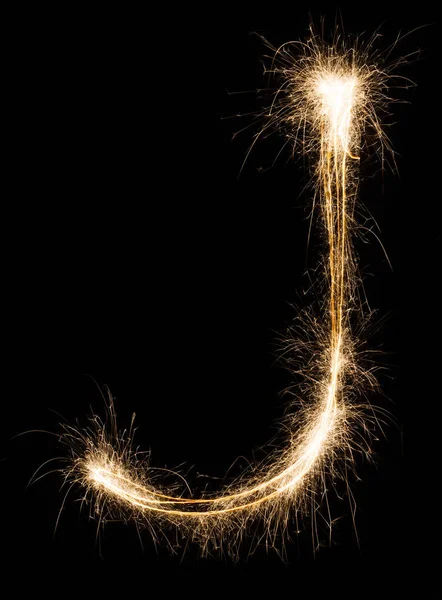 Carta em inglês J do alfabeto sparklers sobre fundo preto . — Fotografia de Stock