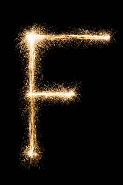 English Letter F from sparklers alphabet on black background. — Stock Photo, Image