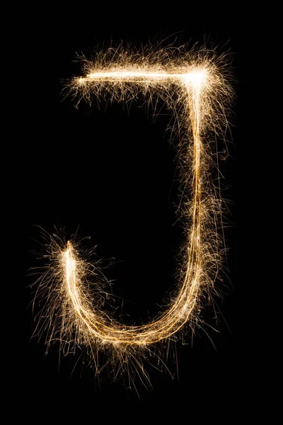 Lettre anglaise J de l'alphabet sparklers sur fond noir . — Photo