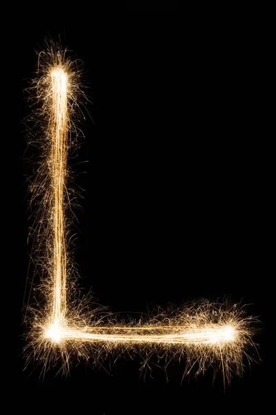 Letra em inglês L do alfabeto sparklers sobre fundo preto . — Fotografia de Stock