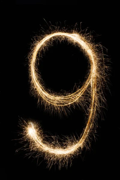 New year font sparkler number nine on black background — Stock Photo, Image