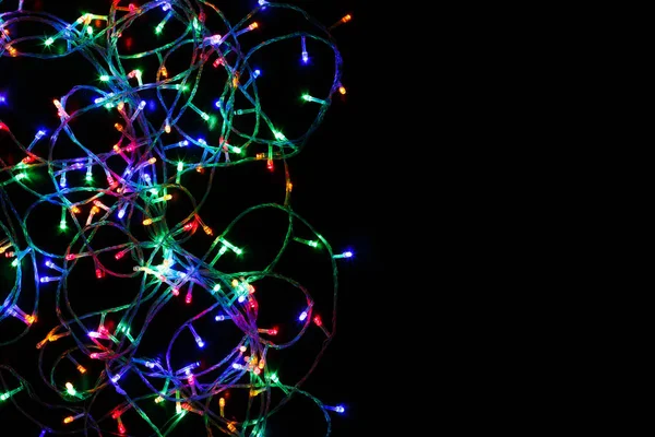 Christmas lights border on black background — Stock Photo, Image