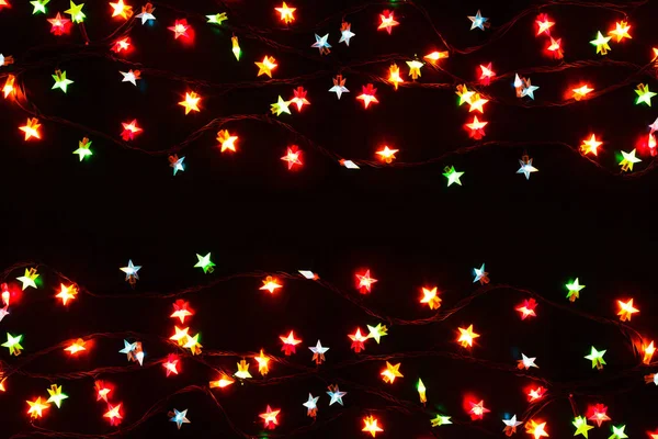 Christmas lights border on black background — Stock Photo, Image