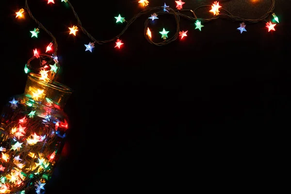 Christmas lights stars border on black background — Stock Photo, Image