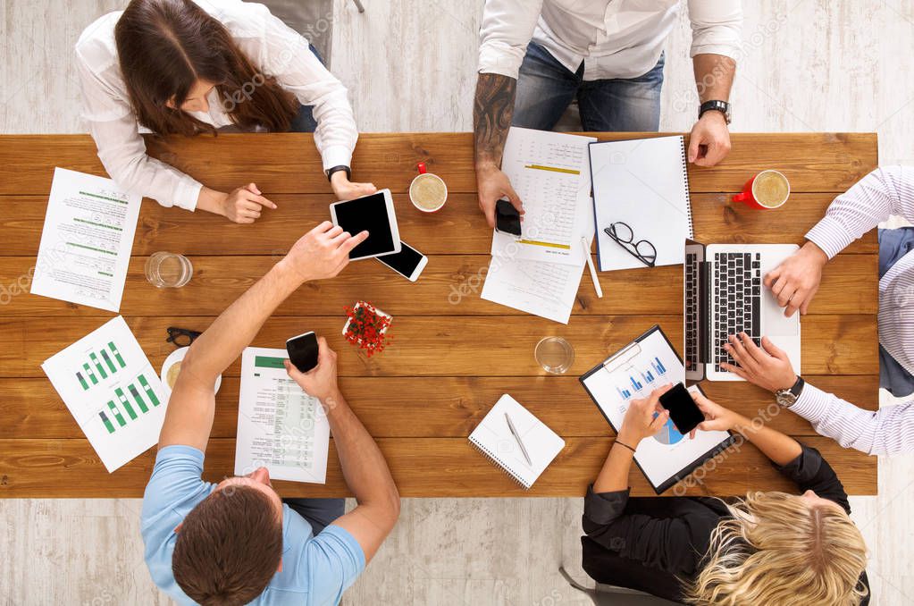 Group of busy business people working in office, top view