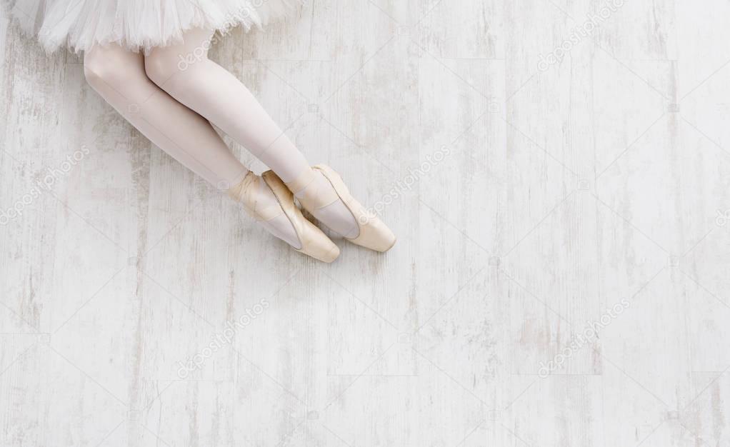 Ballerina in pointe shoes, graceful legs, ballet background