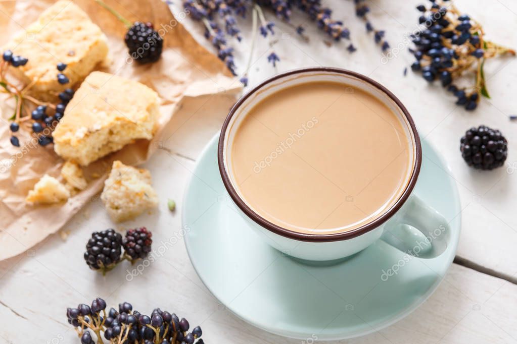 Latte coffee and flowers composition on white wood