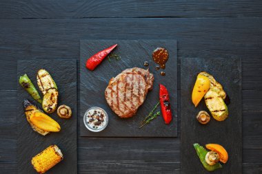 Izgara dana biftek koyu ahşap masa arka planda, üstten görünüm