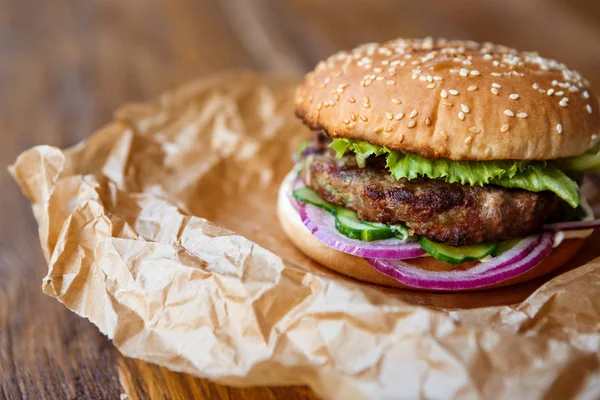 Classic american burger, fast food on wood background