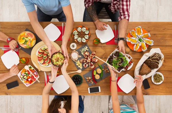 People eat healthy meals at festive table dinner party