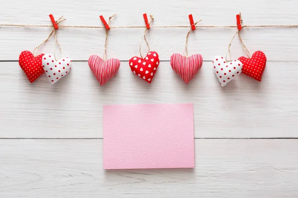 Valentine day background, pillow hearts border on wood, copy space