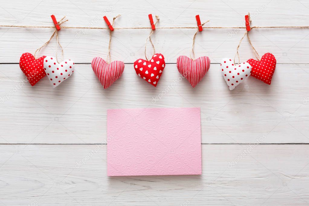 Valentine day background, pillow hearts border on wood, copy space