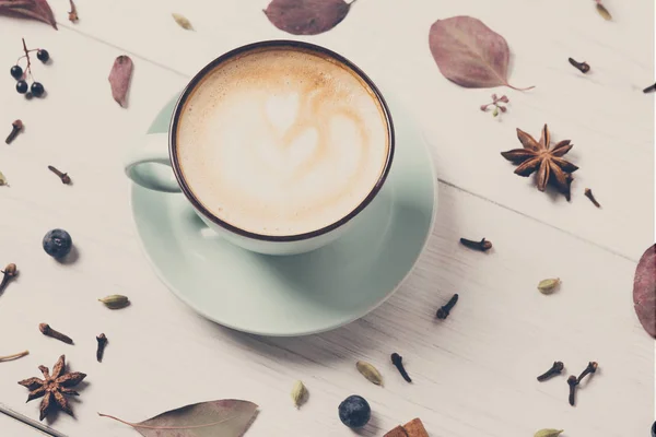 Spicy cappuccino coffee cup on white wood background — Stock Photo, Image