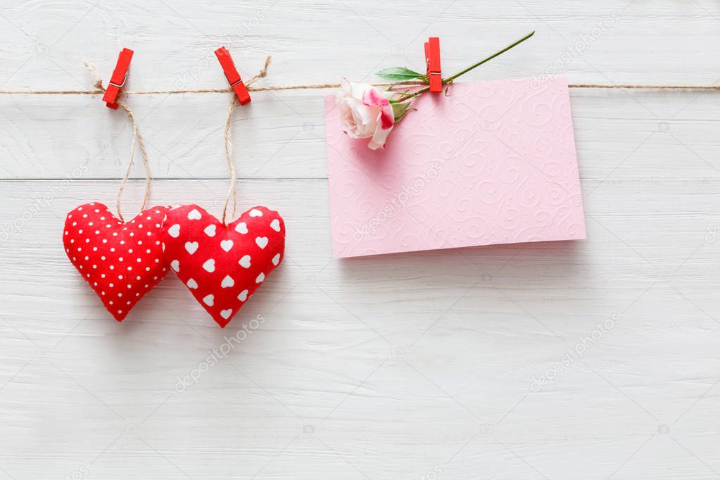Valentine day background, pillow hearts and card on wood