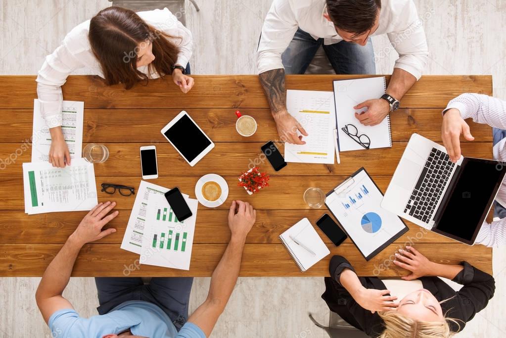 Group of busy business people meeting in office, top view