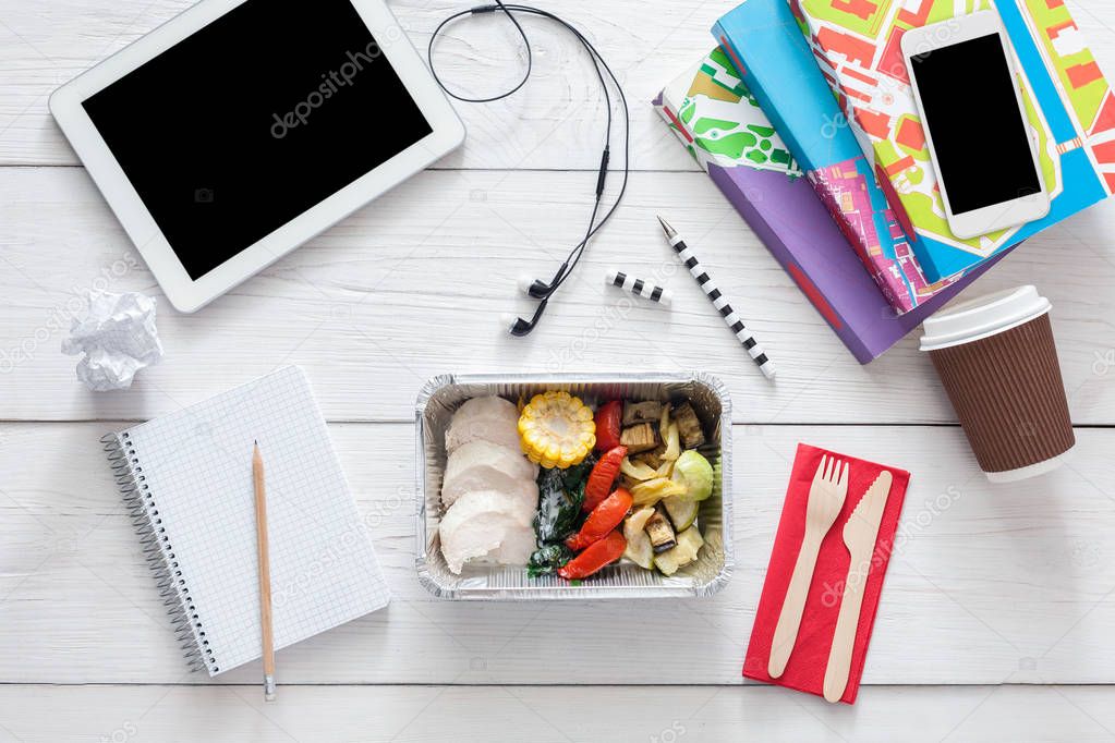 Healthy food, lunch in foil box on student table, diet