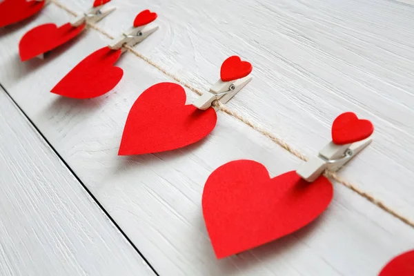 Valentine day background, paper hearts border on wood, closeup — Stock Photo, Image