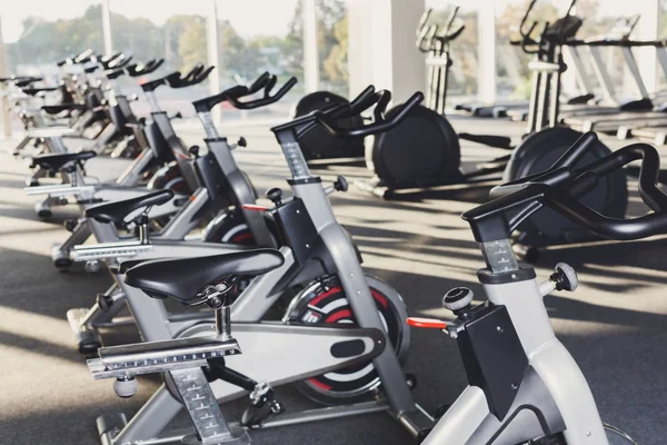 Modern gym interior with equipment, fitness exercise bikes — Stock Photo, Image