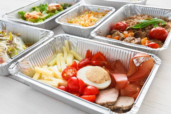 Healthy food take away in foil boxes, meat and vegetables