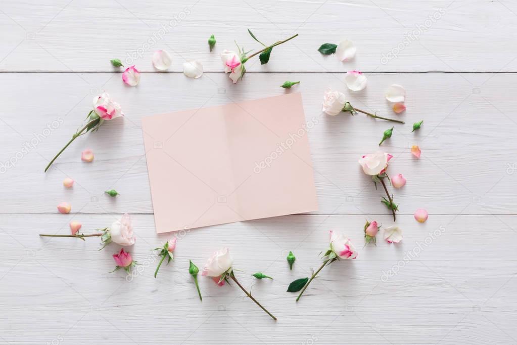 Valentine day background, paper card and flowers on white wood