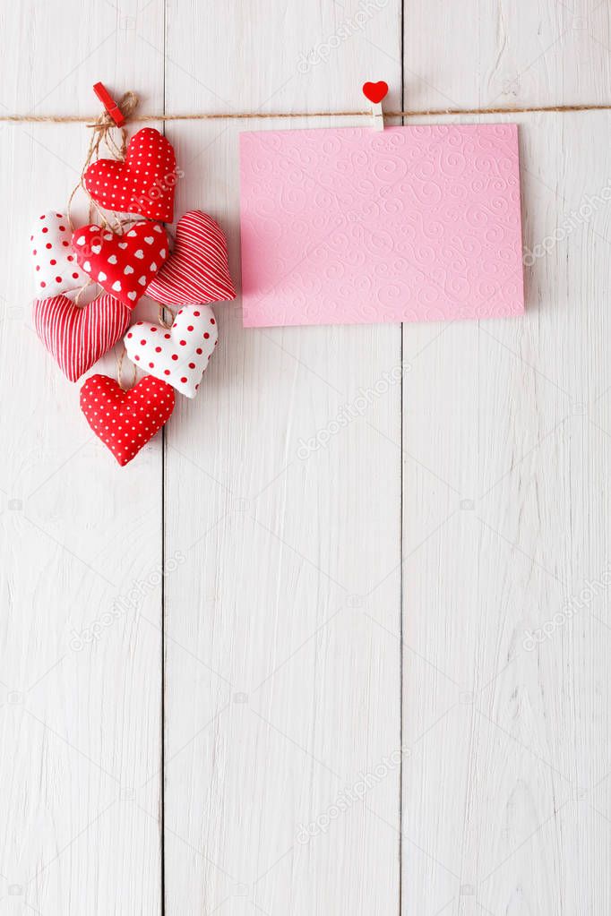 Valentine day background, pillow hearts and card on wood