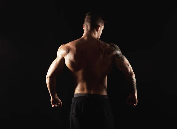 Unrecognizable man shows strong back muscles closeup — Stock Photo, Image