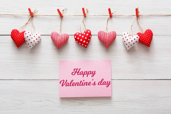 Valentine day background, pillow hearts border on wood, copy space — Stock Photo, Image