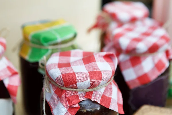 Homemade jams in glass jars for sale on country fair