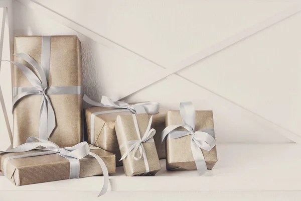 Elegante geschenken, geschenkdozen op witte rekken achtergrond, close-up — Stockfoto