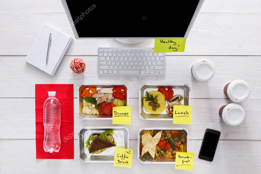 Healthy daily meals in office, top view at wood