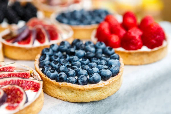 Closeup of blueberry tart dessert tray assorted